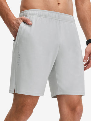 Front lower body shot of model wearing khaki grey breathable running shorts with 4 zipper pockets