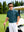 Outdoor shot of a model near a golf cart wearing the cyan massif popular heather print polo, highlighting the heather pattern.
