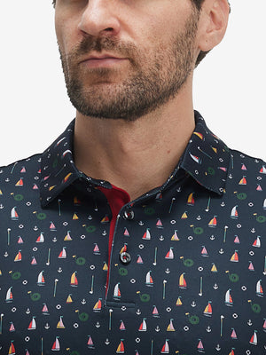 Front view from nose to chest of model wearing the colorful sailboat 4 way stretch print collared polo shirt, showcasing the upper fit