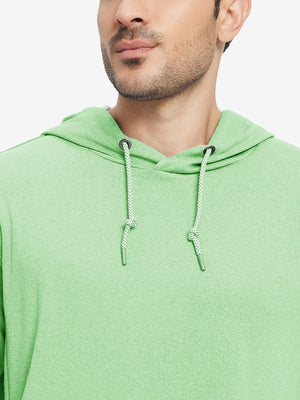Close-up from nose to chest, showing soft heather texture and collar detail of the light green melange hoodie.