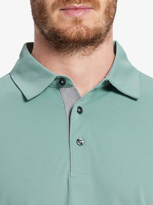 Model wearing the beryl green long sleeve pique polo, showcasing its sleek design and comfort.