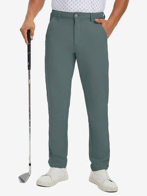 Lightweight moisture wicking dress pants in dark dusty blue, front lower-body with model leaning on golf club.