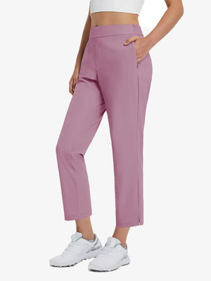 Front lower-body view of model with right hand in pocket wearing PINK Women's 7/8 Ankle Golf Track Pants.