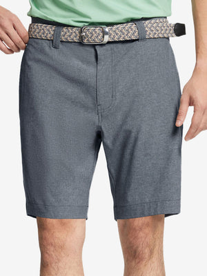 Front view of youth wearing navy Heather Performance Golf Shorts, showing fit and style