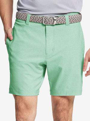 Front view of youth wearing mint green Heather Performance Golf Shorts, showing fit and style