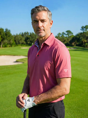 Model in cranberry everyday classic solid polo holding a golf club outdoors, waist-up shot