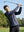 Model swinging a golf club on course, styled in trendy print fleece hoodies with splatter