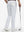 Back lower body shot of model wearing white breathable casual slacks with 4 pockets