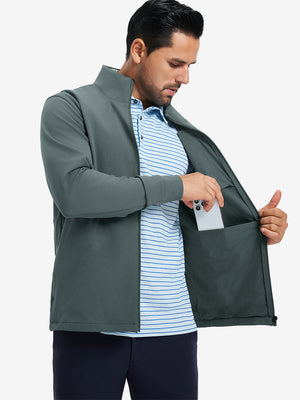 Model wearing water-resistant zip up golf jacket, dark dusty blue, front upper-body with one hand in pocket.