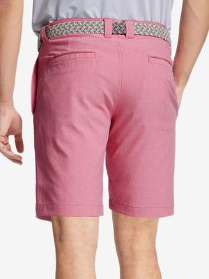 Back view of youth in pink Heather Performance Golf Shorts, highlighting rear design and fit