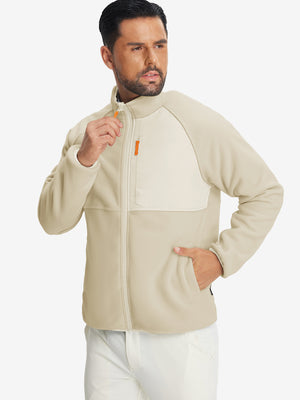 Model wearing the reversible fleece jacket with 5 pockets in khaki, casually posing with one hand in the pocket for a stylish, practical look.