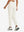Model wearing women's stretch fleece lined water resistant joggers in beige, showing the back lower body view.