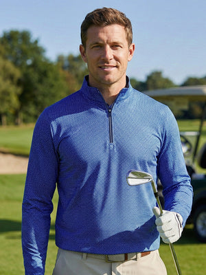 Upper body close-up of model holding golf club in full print lightweight quarter zip pullover, cobalt wave