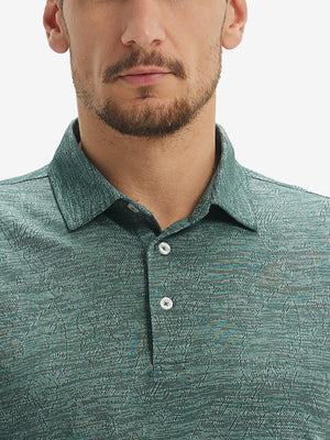 Front view from nose to chest of model wearing green leaf breathable jacquard pattern 3-button golf polo