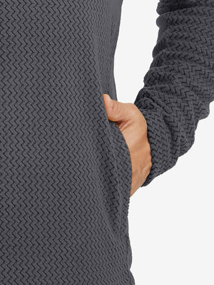 Close-up of pocket detail on midweight warm stretchy quarter zip pullover in grey, showing neat stitching.