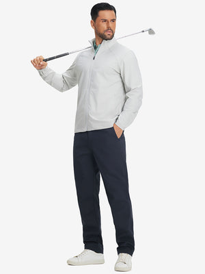 Full-body shot of model holding a golf club while wearing navy thermal water repellent fleece dress pants