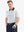 Half-body front view of model with hand in pocket wearing WHITE NAV CLUE Performance Quick Dry Print Golf Polo.