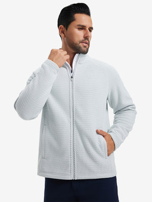 Model with both hands in pockets, wearing soft winter fleece jackets in light grey, warm and relaxed.