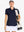 Front half-body of model in NAVY Women's Performance Solid Polo with golf bag