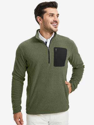 Model with one hand in side pocket, wearing midweight warm stretchy quarter zip pullover in green.