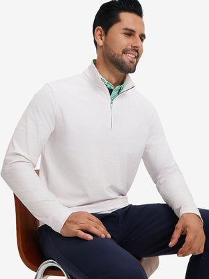 Model seated on chair, wearing full print quarter zip pullover in orange line, casual upper body view.