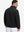 Back view of the model in the reversible fleece jacket with 5 pockets in black.