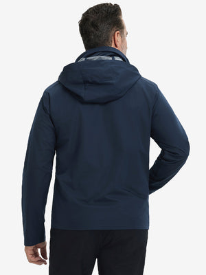 Back view of model in lightweight water-repellent softshell hooded jacket showing fit and structure in navy.