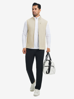 Lifestyle shots of water-resistant fleece golf vests in light khaki, worn while holding golf bag