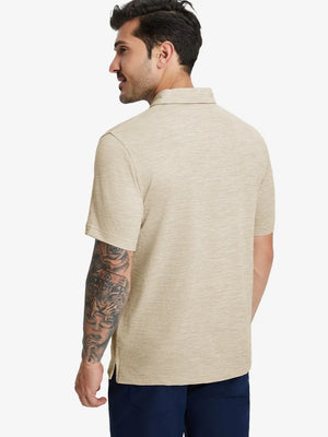 Back half-body view of model in LIGHT KHAKI HEATHER Premium Stretch Heather Polo.