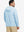 Back upper view of model wearing casual solid fleece hoodies pullover in light blue, showing smooth seams.