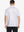 Back half-body view of model in WHITE GEO Performance Quick Dry Print Golf Polo.