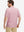 Back half-body of model in pink beach palm stretch printed collarless henley golf shirts