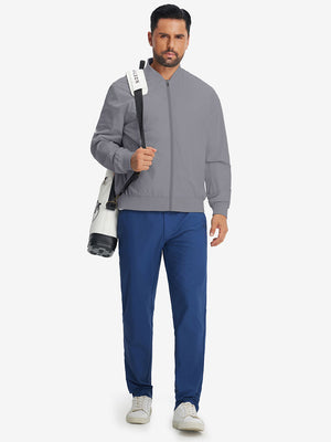 Model carrying golf bag in casual windproof bomber jacket, sporty look in neutral grey
