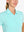 Close-up front view from nose to chest in BLUE LIGHT Women's Performance Solid Polo