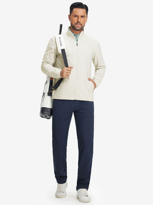Model carrying tennis bag in lightweight water-resistant outerwear jacket, sporty beige look