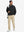 Model carrying golf bag in casual windproof bomber jacket, sporty look in black