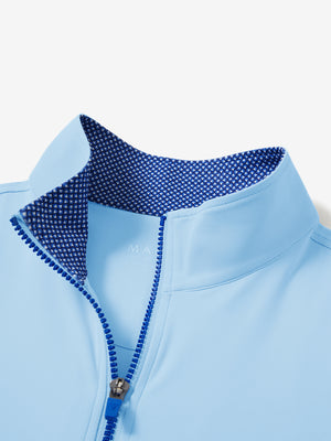 Zipper and inner pattern detail of the print collar quarter zip golf vest in light blue, highlighting design.