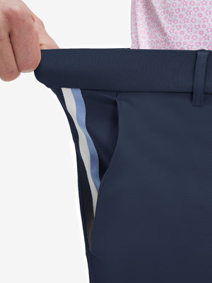 Detail view of elastic waistband on navy breathable casual slacks with 4 pockets