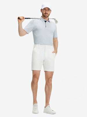 Full-body shot of a model holding a golf club, wearing the navy feather weight jacquard polo shirts and pants