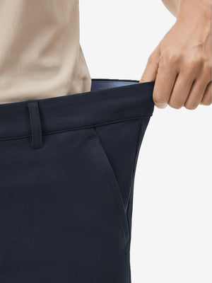 Detail view of elastic waistband on navy women's regular fit stretchy golf pants