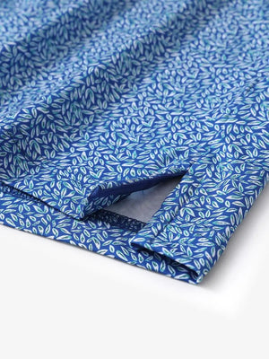Hem slit detail of MAELREG Performance Jersey Print Polo in Blue Small Leaf – comfort & movement