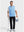 Front full body shot of model wearing light blue melange lightweight sleeveless quarter zip golf vest, holding a golf club in one hand and carrying a basket of golf balls in the other hand