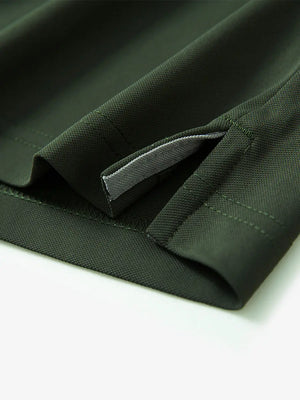 Detail view of the olive green long sleeve pique polo, emphasizing the hem opening and refined design