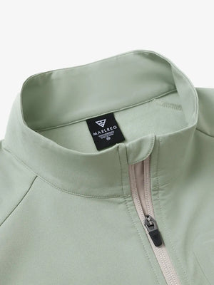 Detail view of the light green windproof golf vest, focusing on the collar design and zipper closure.