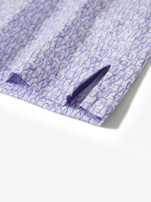 Hem slit detail of the purple wine glass lightweight print long sleeve polo, showing fine stitching and finish.
