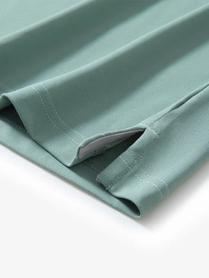 Detail view of the beryl green long sleeve pique polo, focusing on the hem opening and sleek design.