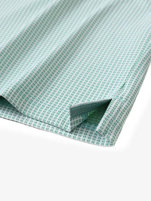 Close-up of hem slit detail on EMERALD Elegant Performance Jacquard Polo
