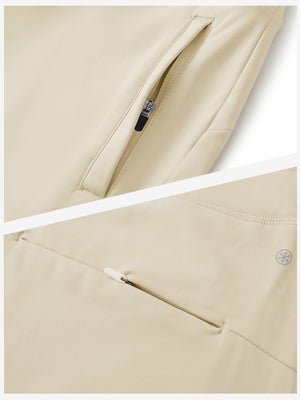 Detailed view of the front side pocket on women's stretch fleece lined water resistant joggers in light khaki, showing stitching and design.