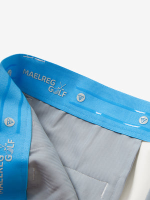 Inside waistband detail of water-resistant golf stretch nylon pants featuring maelreg logo, white.