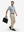 Full-body shot of model holding a briefcase in white light blue grid ultra-light quick dry moisture wicking collared polo shirt